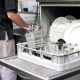 a kitchen employee unloads a one-tray commercial dishwasher