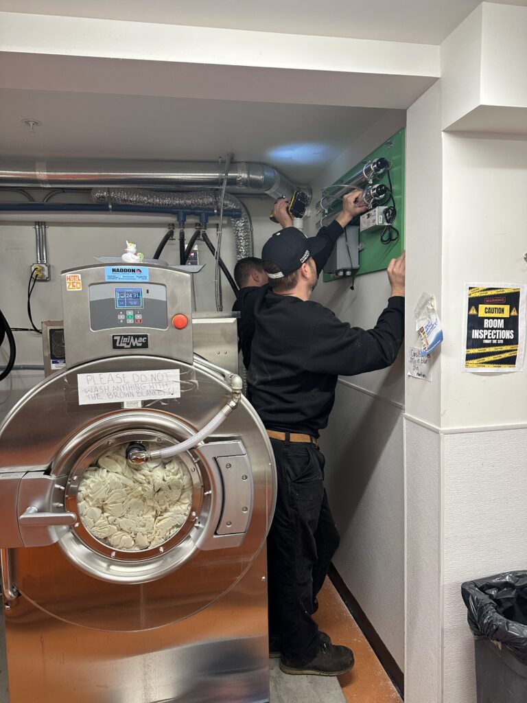 haddon laundry technicians install a lux advanced uv oxidation system at an accent inn