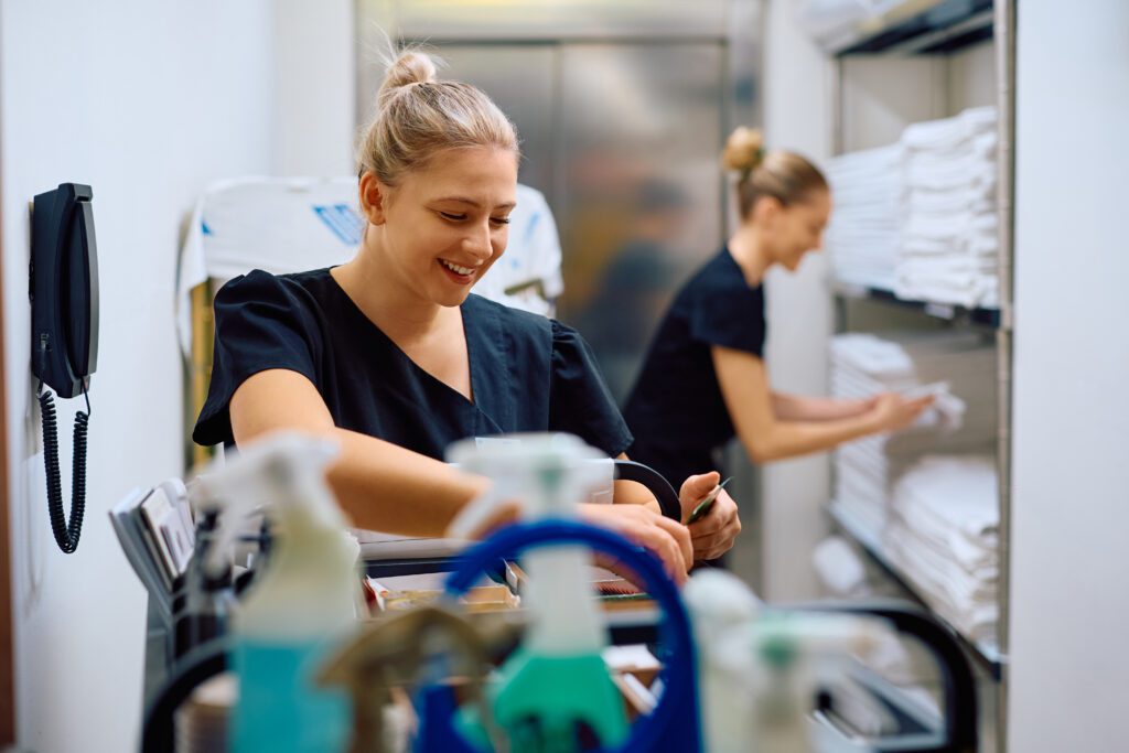 young white maids with blonde hair choose from a cart filled with the best housekeeping chemicals