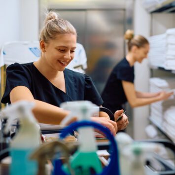 young white maids with blonde hair choose from a cart filled with the best housekeeping chemicals