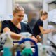 young white maids with blonde hair choose from a cart filled with the best housekeeping chemicals